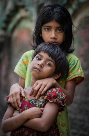Two sisters in front of a wall